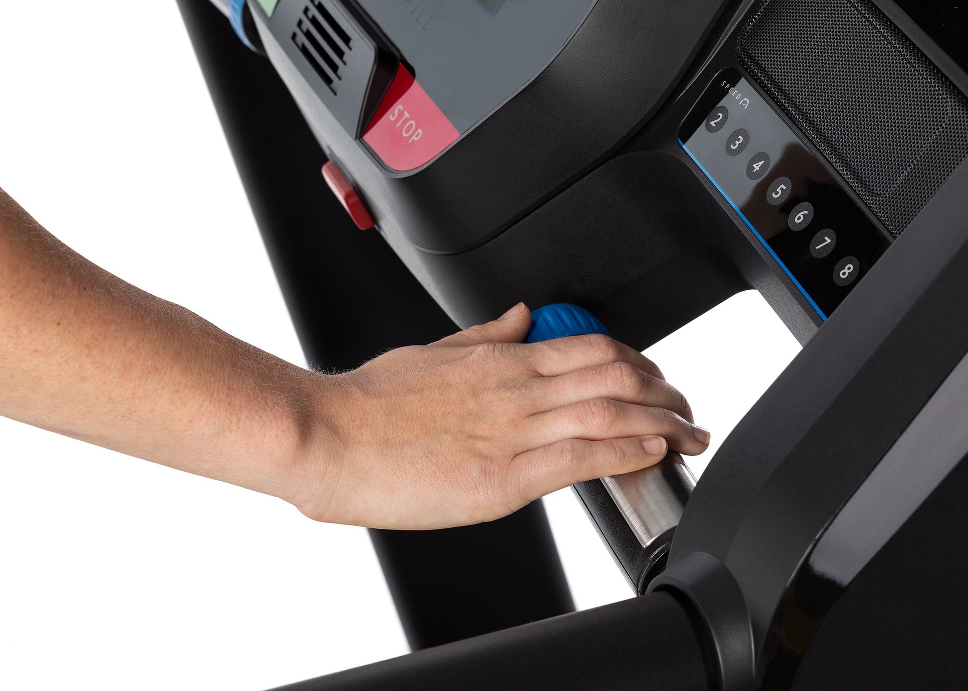Person adjusting a treadmill with a close-up of the hand and control panel.